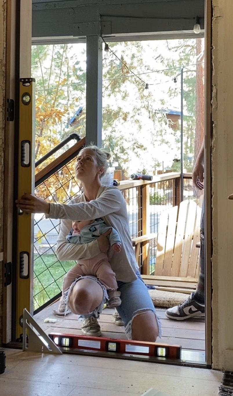 Checking the level of a door frame in a partially constructed space. 
